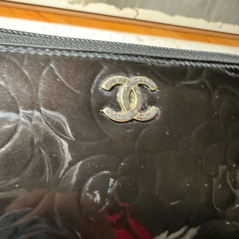 Authentic  Chanel Camelia patent leather zip around‎ wallet long